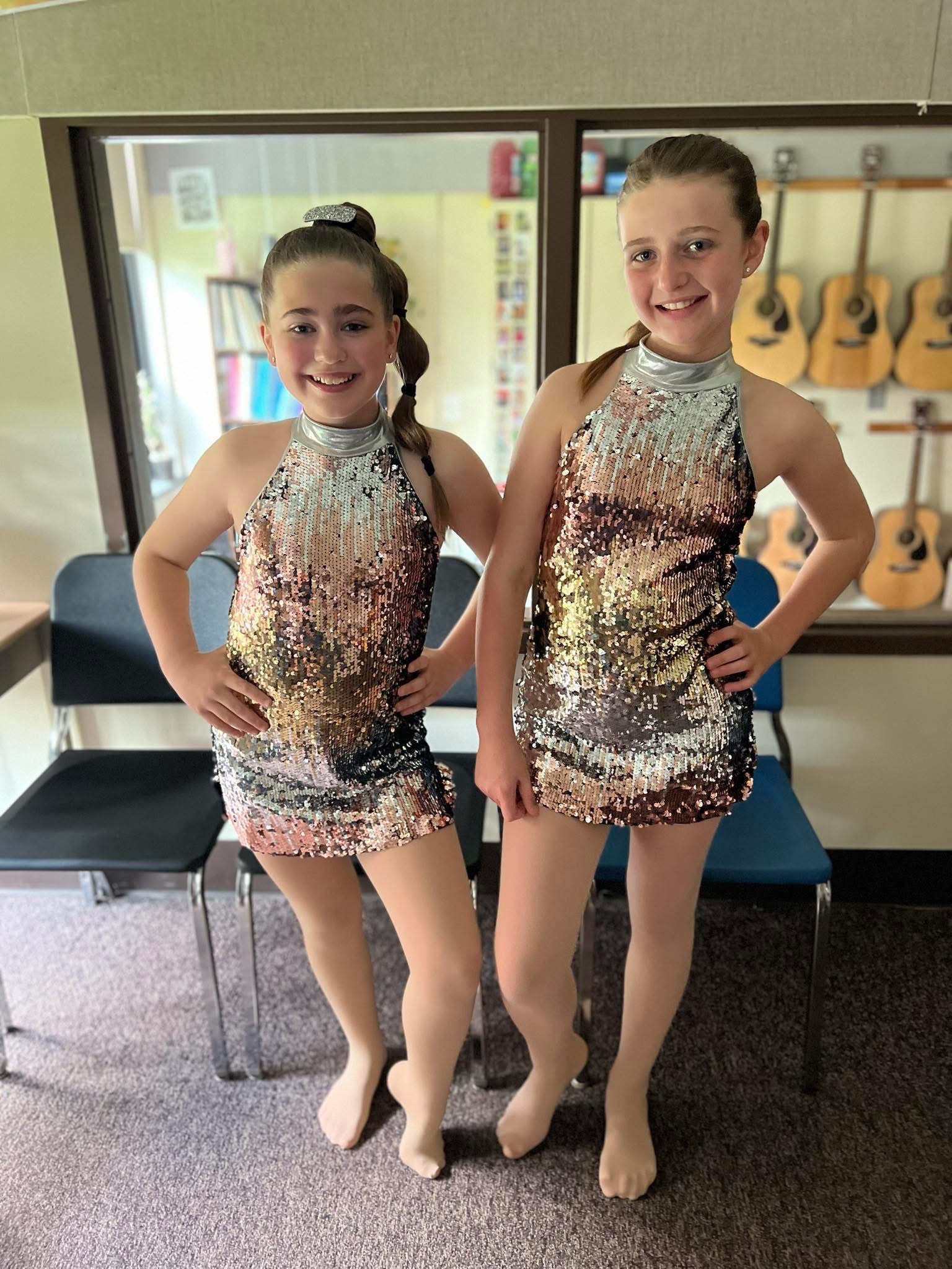 Two young performers in sequined costumes